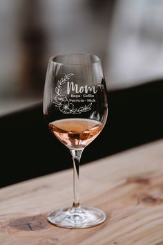 a wine glass sitting on top of a wooden table