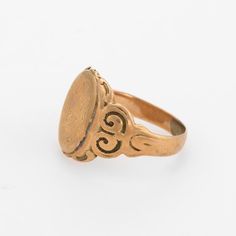 This is part of Chairish’s Fine Jewelry assortment.  Lovely antique Victorian signet ring (circa 1880s to 1900s), crafted in 10 karat rose gold.   The centre oval is inscribed yet due to wear we are unable to decipher the letters.   The side shoulders feature a pretty swirling design that terminates to the oval mount. The saddle of the ring is low and allows the ring to sit flat on the finger.     The ring is in good condition with patina and wear evident. We tend not to clean our antique pieces Victorian 14k Gold Intaglio Engraved Ring, Victorian 14k Gold Signet Ring With Intaglio, Heirloom Oval Signet Ring, Victorian Engraved Yellow Gold Ring, Victorian 14k Gold Engraved Ring, Victorian Engraved Oval Ring, Antique Oval Signet Ring For Gift, Oval Antique Signet Ring As Gift, Victorian Oval Engraved Ring