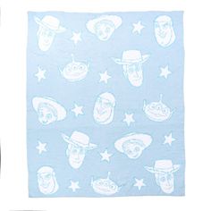 a blue towel with cartoon heads on it and stars in the sky around them, as well as an illustration of people's faces