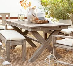 a wooden table with white cushions on it