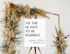 an easel with a sign that says tis the season to be married on it