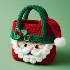 a crocheted christmas bag with a santa clause on it's face and beard