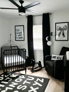 a baby's room with black and white decor