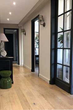 Lors de la rénovation de cet appartement à Neuilly, nous avons remplacer le parquet existant très abimé par un sol plancher de @parqueterienouv, les murs et l'encadrement des portes ont été repeint avec des peintures de chez @farrowball Black Trim Interior, Black French Doors, Narrow Hallway Decorating, Home Hall Design, Old Apartments, Dark Home Decor, Living Room Color Schemes, Hall Design, Home Organization Hacks