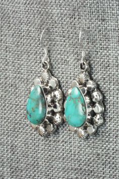 These turquoise and sterling silver earrings were made by Navajo silversmith Sadie Jim. The back is signed RB and stamped .925.Height: 1 1/2"Width: 3/4"Free shipping on all orders! We ship with USPS and always include tracking. All orders ship within a day of payment.Returns are accepted up to 30 days after you receive your order. Just send us a message. Our shop offers cash back or store credit. The item must be returned in new condition. Southwestern Teardrop Concho Earrings, Southwestern Teardrop Sterling Silver Earrings, Silver Southwestern Drop Earrings, Nickel-free Turquoise Sterling Silver Earrings, Western Style Turquoise Nickel-free Earrings, Southwestern Turquoise Nickel-free Hoop Earrings, Turquoise Nickel-free Southwestern Earrings, Native American Jewelry, Turquoise Sterling Silver