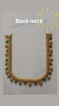 a gold necklace with beads and green leaves on the bottom is displayed in front of a white background