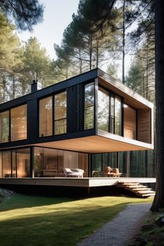 a modern house in the woods surrounded by trees