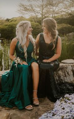 two women sitting next to each other in dresses