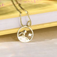 Delicate necklace with a motif from the story of The Little Prince - boy watching the night sky ִֶָ☾. A piece that combines precise processing and recycled materials.  We can decorate the back of the jewelery with an engraving of a short text of your choice.  If you want a different color combination of the base of the pendant and the stars, please do not hesitate to contact us ❤ (This customization is only possible on gold and platinum necklaces, silver necklaces are only available in single co Property Of, Anchor Chain, 18k Gold Necklace, Little Prince, The Little Prince, Delicate Necklace, Round Pendant, Gold Platinum, Necklace Silver