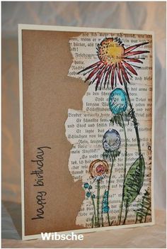 a card with flowers on it that says happy new year and is made out of old book pages