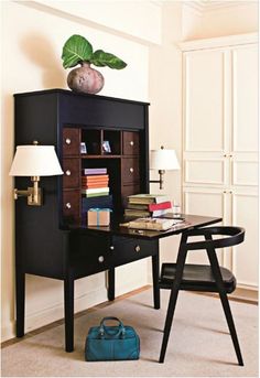 a black desk with a blue bag and lamp