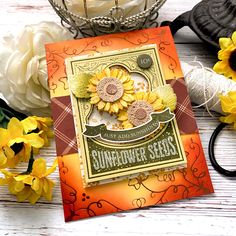 a card with sunflower seeds on it next to some yarn and flowers in a basket