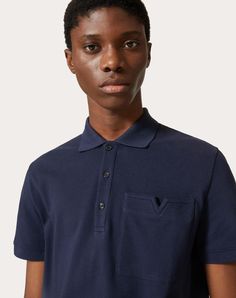 Valentino cotton piqué polo shirt with topstitched V Detail - Regular fit - V Detail stitched on left breast pocket as worn - Ribbed collar and cuffs - Composition: 100% Cotton - Length: 71 cm / 28 in. from the back of the neck in a size M - The model is 187 cm / 6'1" tall and wears a size M - Made in Italy The look of the model is completed by Valentino Garavani Freedots Shoes. Luxury Men's Cotton T-shirt, Navy Cotton Polo Shirt, Valentino Tshirt, Valentino Embroidery Detail, Cotton Polo T-shirt With Embroidered Logo, Pique Polo Shirt, Collar And Cuff, Valentino Garavani, Calf Skin