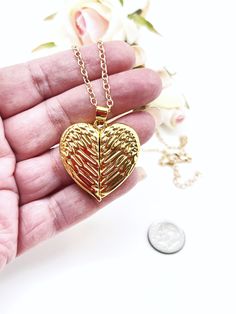 "Keep someone special to you in this very detailed, fold over, Angel Wing Photo locket. Tiny magnets on both sides hold the wings closed protecting your photo. I used double sided scotch tape to hold my photo in place. Sorry, but I do not do photo inserts or engraving.  The gold plated chain is 26\" long with a 1 7/8\" extender. I can make it shorter upon request.  I also carry a personalized one in silver. Here is the link: https://etsy.me/3EQVLRV For more lockets and to see the rest of my collection, please visit: www.ShalomJewelry.Etsy.com" Metal Wing-shaped Jewelry Gift, Wing-shaped Jewelry For Valentine's Day Gift, Valentine's Day Gift Jewelry Wing-shaped, Valentine's Day Wing-shaped Jewelry Gift, Gold Angel Wings, Photo Locket Necklace, Gold Angel, Scotch Tape, One Photo