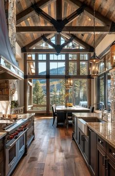 a kitchen with wood floors and large windows on the ceiling, along with granite counter tops