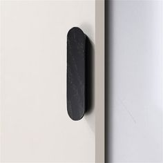 a black door handle on a white door