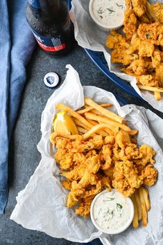 two plates filled with fried chicken and fries