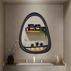 there is a mirror on the wall above a sink with plants and jars in it