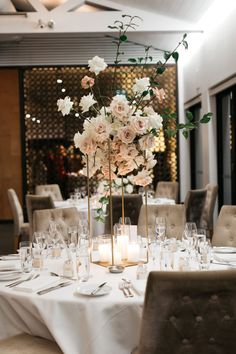 the centerpiece is surrounded by candles and flowers