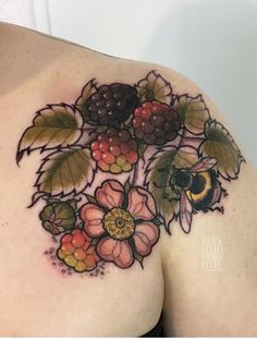 a woman's chest with flowers and a bee on it