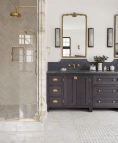 a bathroom with two sinks and mirrors on the wall