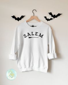 Salem Sweatshirt, Souvenir Shirt, Vacation Shirt, Witchy Gifts, Home Town Shirt, Salem Mass, Massachusetts, College Shirts, Salem Witches, Halloween Shirt, Witch Shirt, Halloween Shirts, Fall Sweatshirt, Fall T-Shirts This soft sweatshirt has a loose fit for a comfortable feel. With durable print, it will be a walking billboard for years to come. -Loose fit -50% Cotton; 50% Polyester (fibre content may vary for different colors) -Unisex - Fits true to size (see size chart for reference) - If you Relaxed Fit Crew Neck Shirt With Lettering, Crew Neck Shirt With Lettering In Relaxed Fit, College Crew Neck Shirt With Screen Print, Crew Neck College Shirt With Screen Print, Salem Sweatshirt, Bachelorette Party Matching, Salem Witches, Salem Mass, Souvenir Shirt