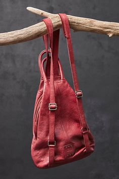 Designed to be slung over your shoulder or styled as a backpack, this soft leather sling bag from our We The Free collection features zippered details and defined top handles for added classic shape. * Lined interior * Zipper top closure * Adjustable belted strap | We The Free Soho Convertible Sling Bag at Free People in Red Red Leather Backpack With Zipper Closure, Leather Sling Bag, Zipper Top, Zipper Detail, Boho Clothing, Sling Bag, Soho, Soft Leather, Convertible