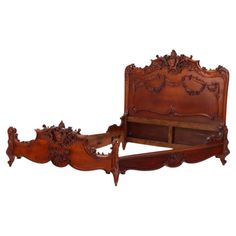 an antique wooden bed frame with intricate carvings