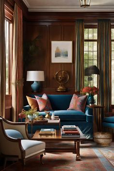 a living room with blue couches and colorful pillows on the sofa, along with other furniture