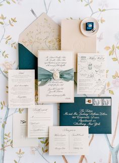 the wedding stationery is laid out on top of each other