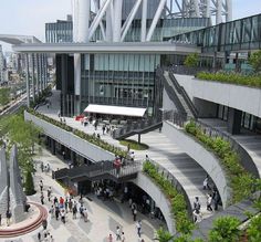 an aerial view of people walking and sitting on the steps in front of a building