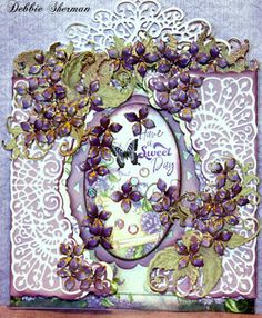 a card with purple flowers and butterflies on it