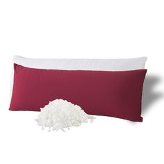 a red pillow and some white pillows on a white background