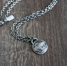 A vintage Buffalo Nickel coin has been forged into a pendant for this men's chain necklace. The nickel has been domed, giving it more dimension, and then oxidized and sanded to bring out all the incredible detail. It hangs from strong drawn cable chain chain and is secured with a lobster clasp.Please use guide in last photo to choose your chain length from the drop down menu.See this pendant necklace with the Indian (as shown in last photo) here https://www.etsy.com/listing/905271571/indian-head Sterling Silver Oxidized Medallion Necklace, Sterling Silver Medallion Necklace With Oxidized Finish, Oxidized Sterling Silver Medallion Necklace, Sterling Silver Oxidized Medallion Coin Necklace, Sterling Silver Medallion Coin Necklace With Oxidized Finish, Sterling Silver Oxidized Coin Necklace, Sterling Silver Coin Necklace With Oxidized Finish, Classic Oxidized Round Pendant Jewelry, Silver Coin Necklace With Oxidized Round Pendant