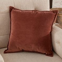 a brown pillow sitting on top of a chair