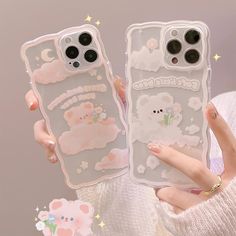 two phone cases with cartoon animals on them, one is clear and the other is pink