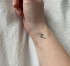 a woman's arm with a small tattoo on it, and the word love is written