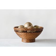 a wicker bowl filled with golden apples