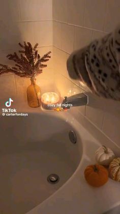 a bathtub with candles and pumpkins in it