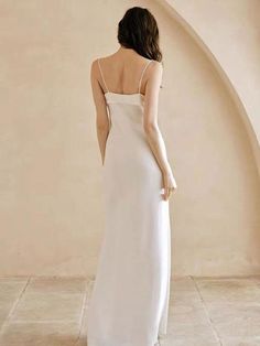 the back of a woman wearing a white dress