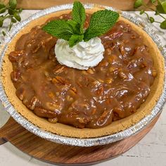 a pie topped with whipped cream and chocolate