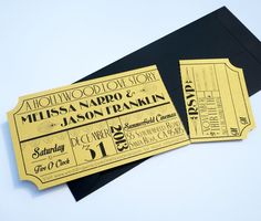 two black and gold ticket style wedding cards with the word hollywood on them, sitting next to each other