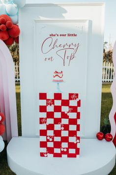 there is a red and white checkerboard sign on the side of a chair