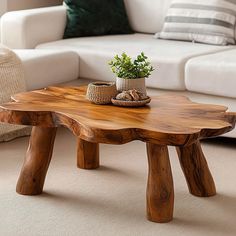 a wooden table sitting in front of a white couch