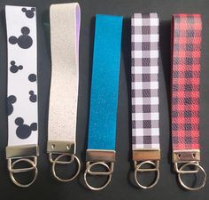 four different colored lanyards with mickey mouse design on them, all lined up in a row