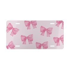 a pink bow license plate on a white background