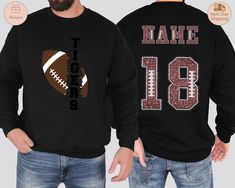 Custom Football Sweatshirt,Football Name and Number Sweater, Personalized Football Sweater,Custom Football Hoodie,Game Day Football Sweater HOW TO ORDER: 👕 Select your size in the drop-down menu. 👕 Select your size in the drop-down menu. 🛒 Click Add to Cart, then choose your shipping option.  SIZING: 📏 All sweatshirts and t-shirts are unisex, classic fit. Please refer to the size chart in the listing photos for details. 👕 Easy measuring tip: Take your favorite shirt, lay it on a flat surface, and measure the width (armpit to armpit) and length (top to bottom). ⚠️ Sweatshirts and t-shirts are pre-shrunk but may shrink slightly after washing. SHIPPING: 🚚 We have the fastest handmade Production time! Most items ship within 1 days (see each listing's "Estimated arrival" section for more Collegiate Black Sweatshirt For Football Season, Black Football Season Sweatshirt, Black School Spirit Sweatshirt For Sports Events, Black Sports Fan Sweatshirt For Sports Season, Black Sports Fan Sweatshirt, Team-colored Football Season Sweatshirt, Team-colored Varsity Sweatshirt For Football Season, Team-colored Sweatshirt For Football Season, College Football Season Sweatshirt With Team Name