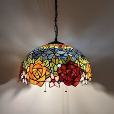 a stained glass lamp hanging from a chain