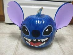 a blue pumpkin with purple ears and big eyes