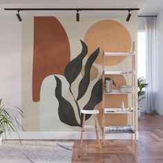 an abstract painting on the wall next to a chair and shelf with a potted plant